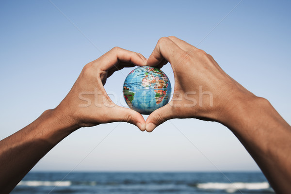 young man with a world globe in his hands  Stock photo © nito