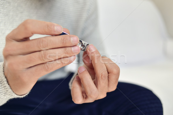 young man cutting his fingernails Stock photo © nito