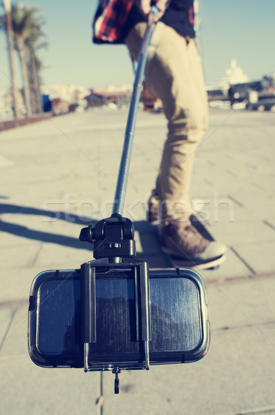 skater taking a self-portrait or a video with a selfie stick Stock photo © nito