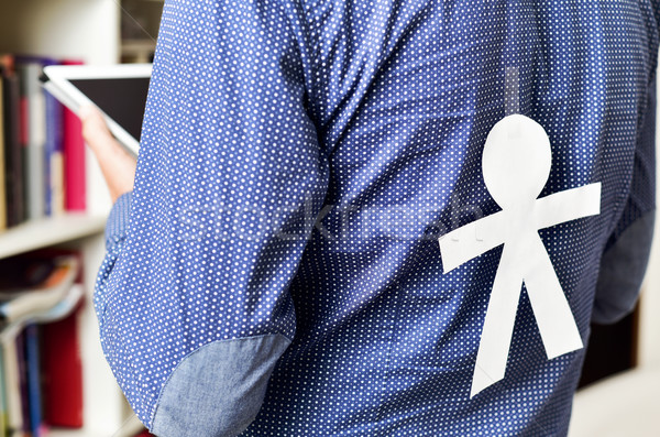 Stock photo: young man with a paper man attached in his back