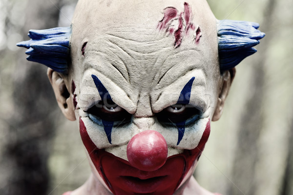 Stock photo: scary evil clown in the woods