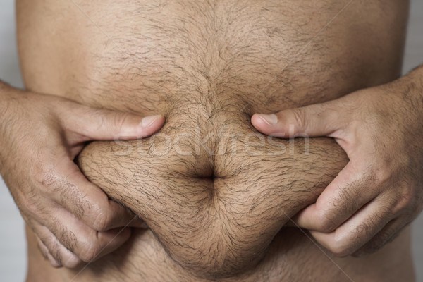 Om grăsime stomac tineri caucazian Imagine de stoc © nito