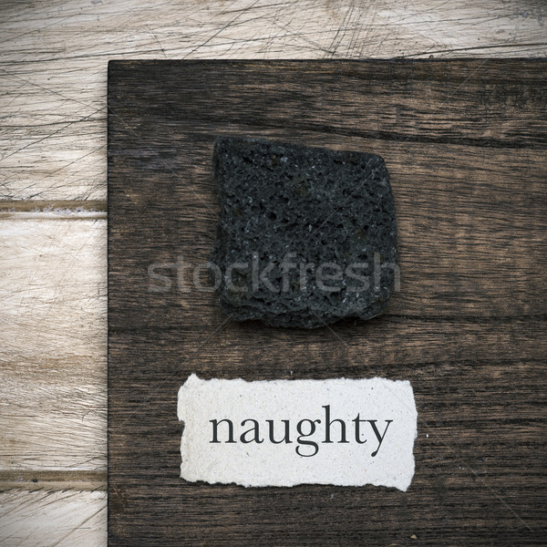 Stock photo: candy coal and word naughty in a piece of paper