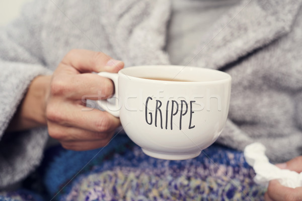 ill man and mug with word grippe, flu in french Stock photo © nito