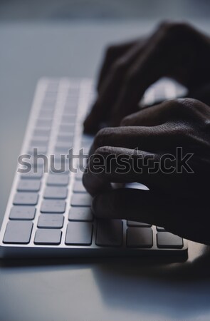 young man typing in a computer keyboard Stock photo © nito