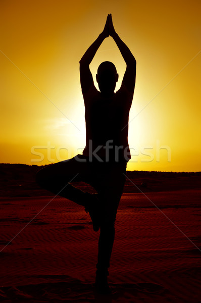 young man doing the yoga tree pose Stock photo © nito