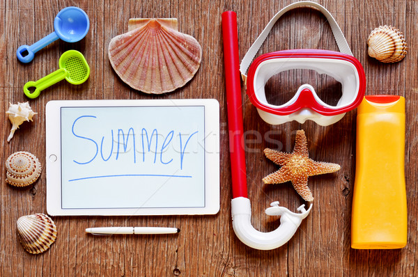 word summer written in a tablet and summer stuff on a rustic woo Stock photo © nito