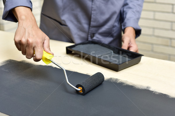 young man painting a wooden board Stock photo © nito