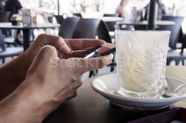 man using a smartphone in the terrace of a cafe Stock photo © nito