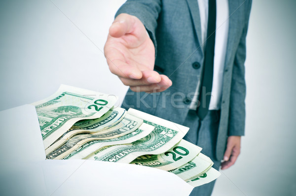 man taking an envelope full of dollar bills Stock photo © nito