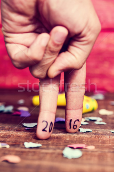 number 2016, as the new year, in the fingers of a young man Stock photo © nito