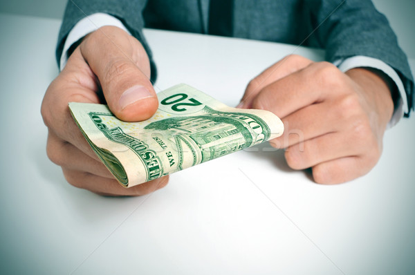man in suit with a wad of american dollar bills Stock photo © nito