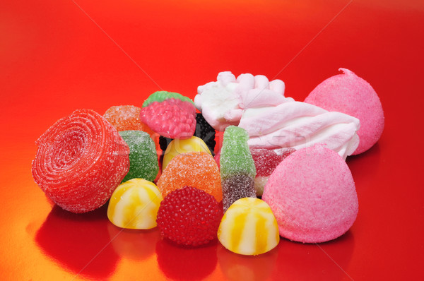 Cukorkák köteg ízletes piros háttér üveg Stock fotó © nito