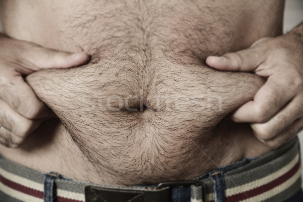 man grabbing the fat of his stomach Stock photo © nito