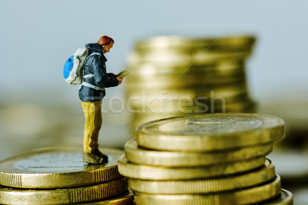miniature traveler on a pile of euro coins Stock photo © nito