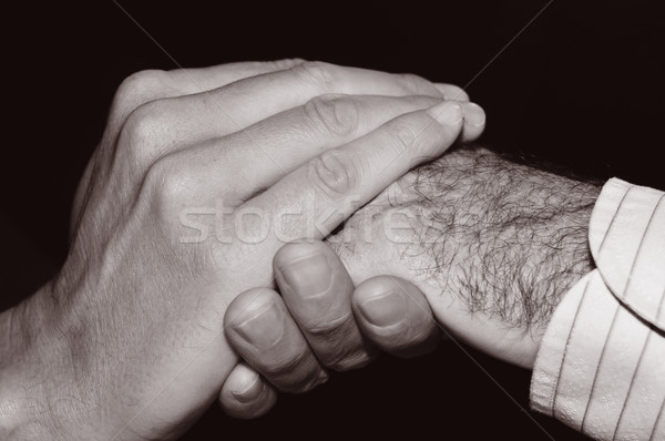 young man holding the hand of an old man, in black and white Stock photo © nito