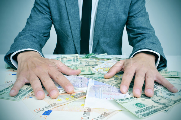 man in suit with dollar and euro bills Stock photo © nito
