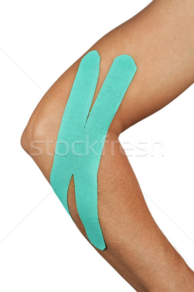 young man with an elastic therapeutic tape in his arm Stock photo © nito