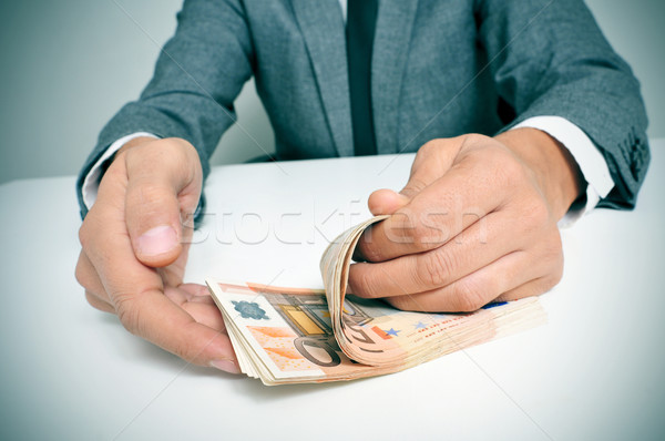 man in suit counting euro bills Stock photo © nito