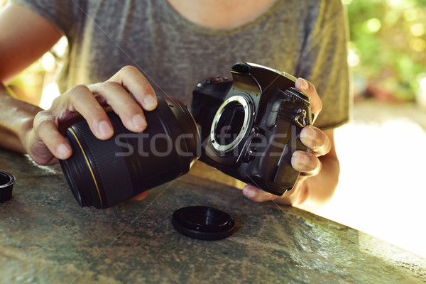 man taking out the lens of his camera Stock photo © nito