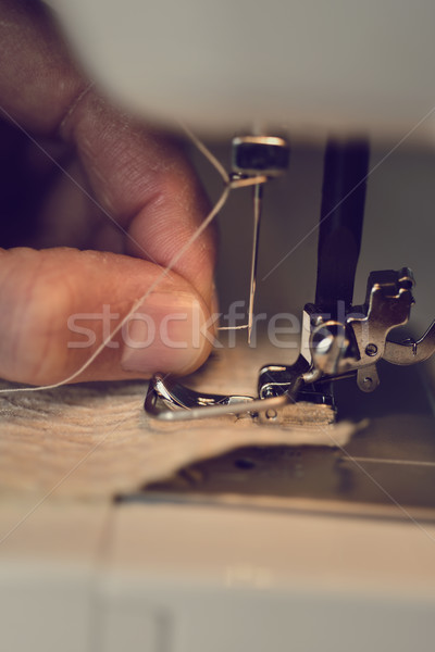 young man using a sewing machine Stock photo © nito