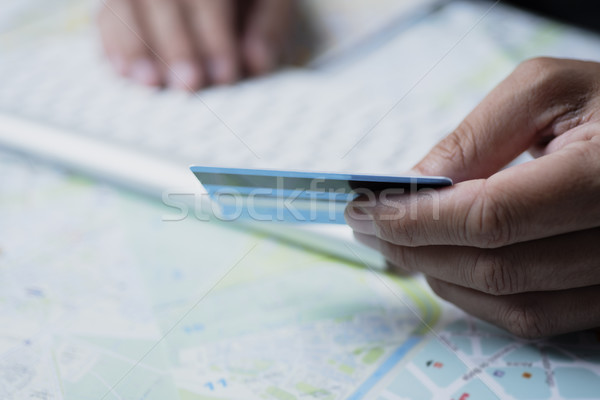 man using a credit card to book a trip Stock photo © nito