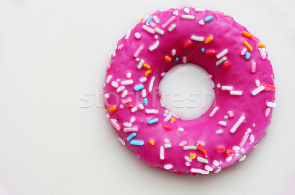 donut coated with a pink frosting and sprinkles of different col Stock photo © nito