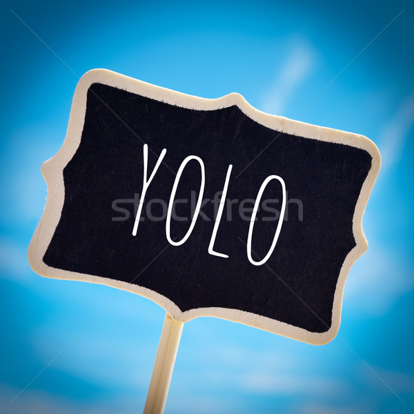 signboard with the word yolo, vignetted Stock photo © nito