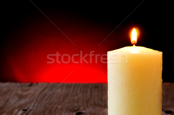 lit candle on a rustic wooden table Stock photo © nito