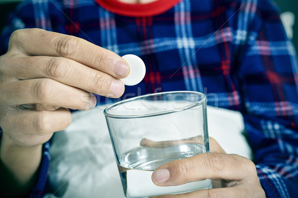 man putting an effervescent tablet into a glass with water Stock photo © nito