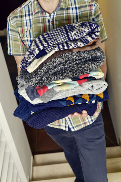 young man with a pile of folded sweaters Stock photo © nito
