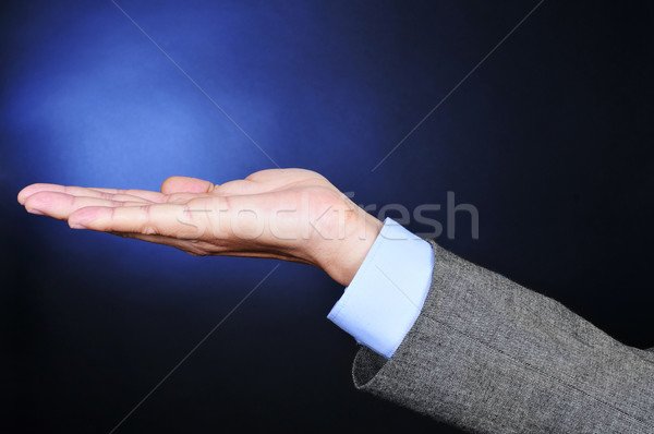 Stock photo: young man in suit with his hand open