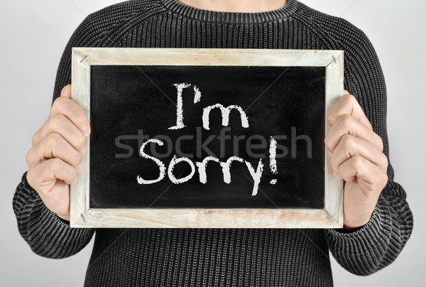 man with a chalkboard with the text I am sorry Stock photo © nito