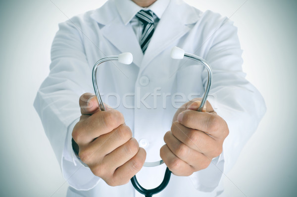 young doctor man with a stethoscope, vignetted Stock photo © nito