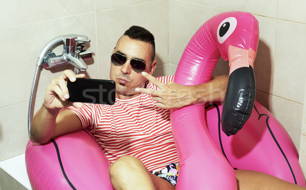 man with a swim ring taking a selfie indoors Stock photo © nito