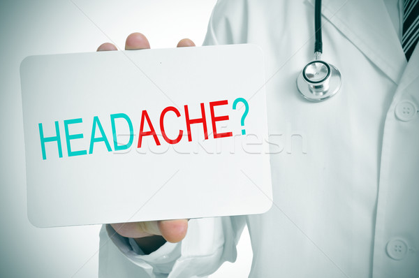 doctor showing a signboard with the question headache? Stock photo © nito