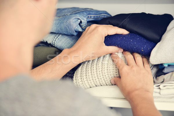 young man arranging the closet Stock photo © nito