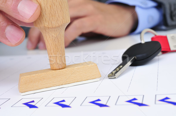 man in office with a rubber stamp and a car key Stock photo © nito