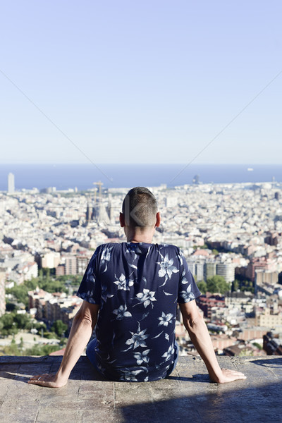 Stock photo: young man with Barcelona, Spain, below him