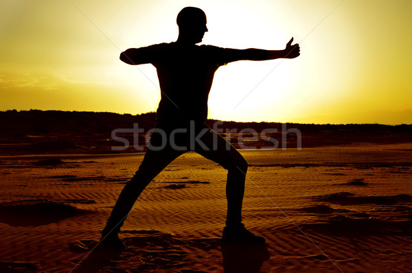 young man doing the yoga archer pose Stock photo © nito