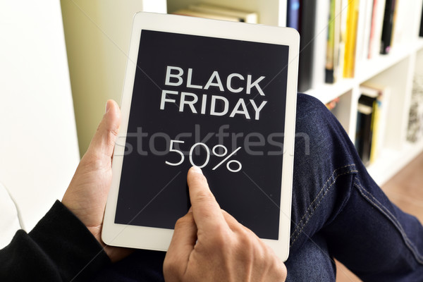 young man with a tablet with the text black friday Stock photo © nito