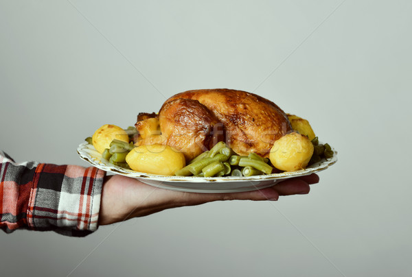 Stock photo: young man with a roast turkey