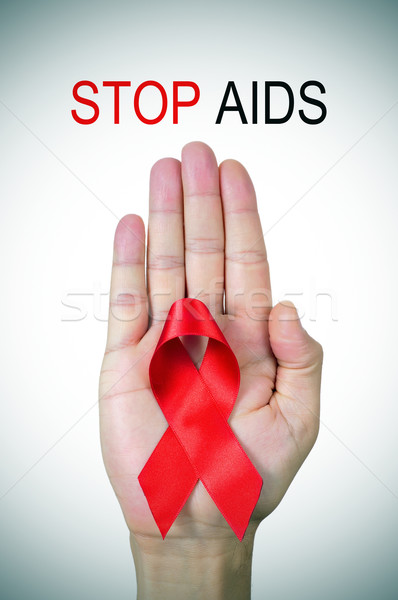 text stop AIDS and a red ribbon in a man hand Stock photo © nito