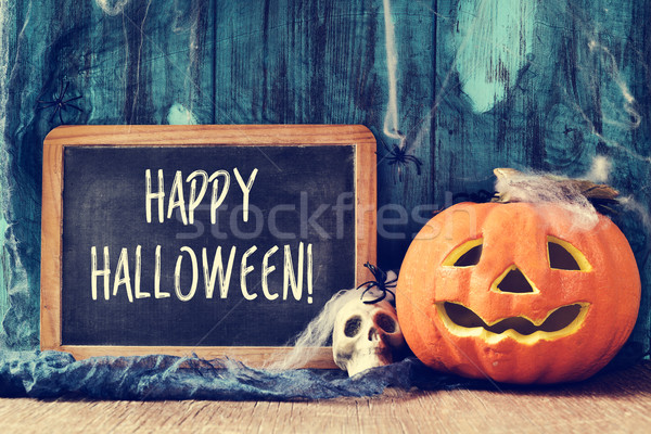 skull, jack-o-lantern and text happy halloween in a chalkboard Stock photo © nito