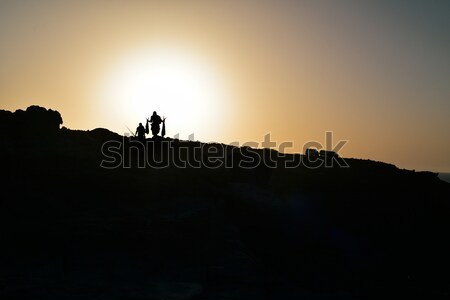 silhouette of fishermen on a cliff at dusk Stock photo © nito