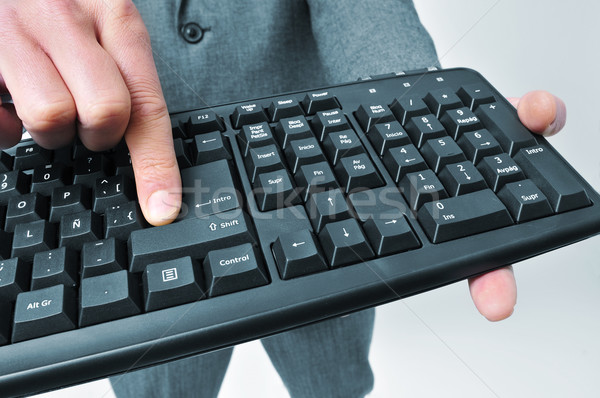 man in suit pressing the enter key of a keyboard Stock photo © nito