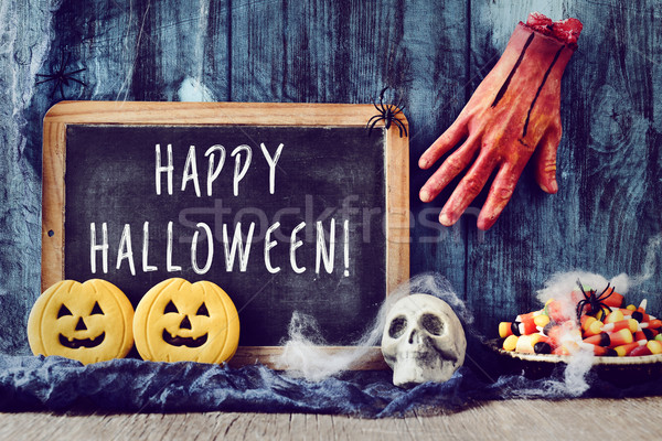 candies, ornaments and text happy halloween in a chalkboard Stock photo © nito