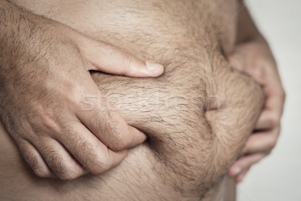 man grabbing the fat of his stomach Stock photo © nito