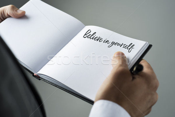 man and notebook with the text believe in yourself Stock photo © nito