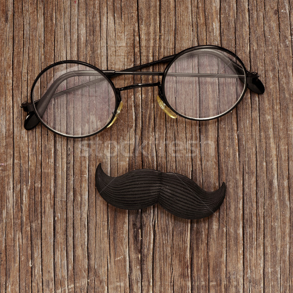 eyeglasses and mustache on a wooden surface Stock photo © nito